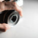 Close-up of hand adjusting vintage camera lens