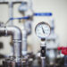 Pressure gauge on industrial pipe system.