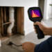Thermal camera inspecting leaking pipes inside wall
