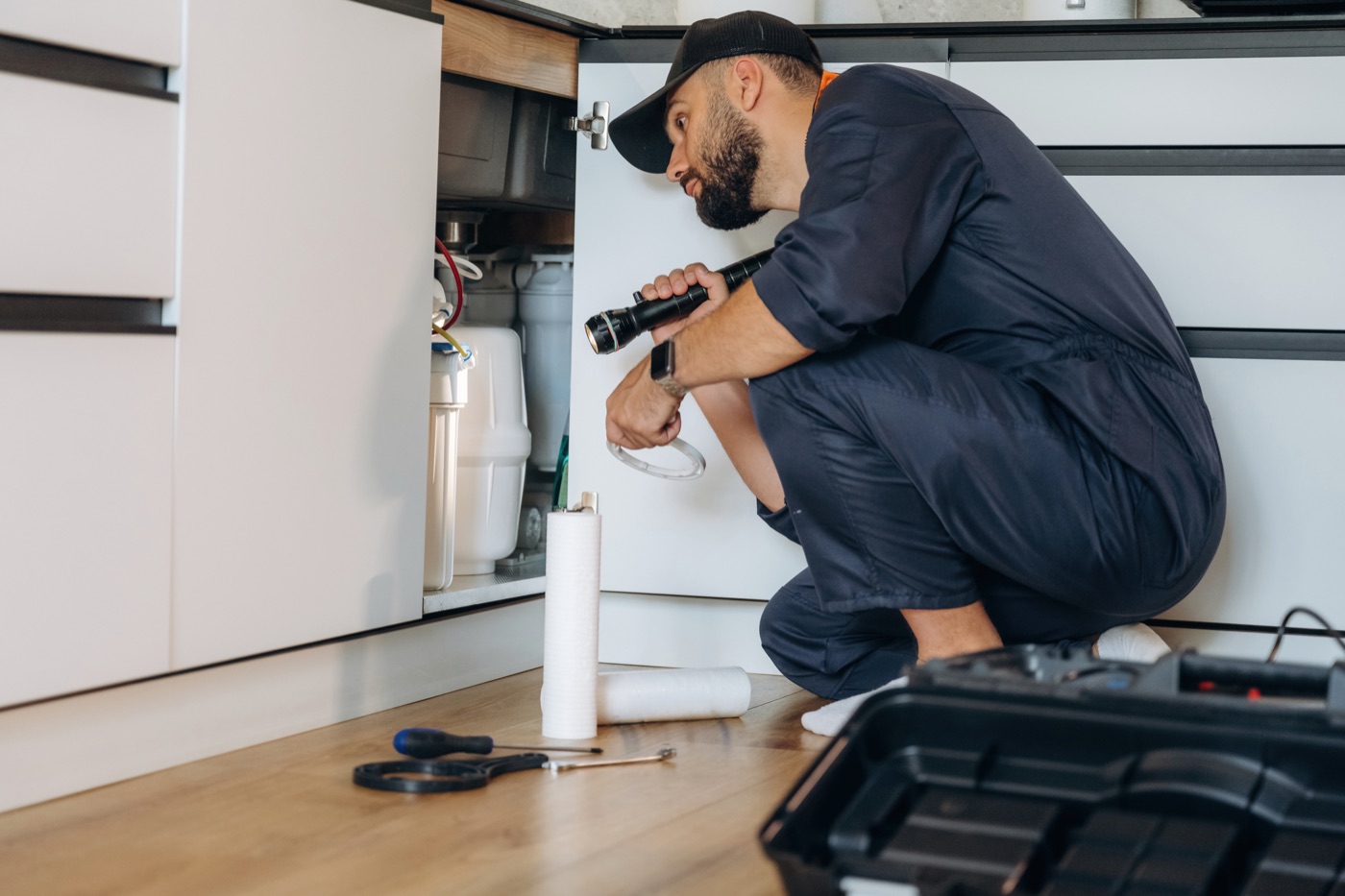 Plumber tracing a hidden water leak under a sink in an Iluka home Plumber tracing a hidden water leak under a sink in an Iluka home