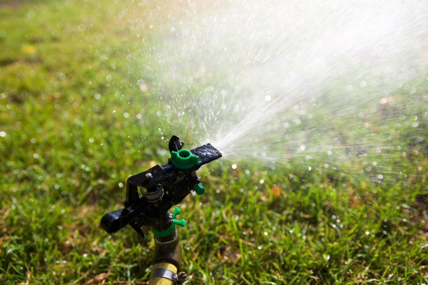 Reticulation sprinkler watering a lawn at an Iluka home Reticulation sprinkler watering a lawn at an Iluka home
