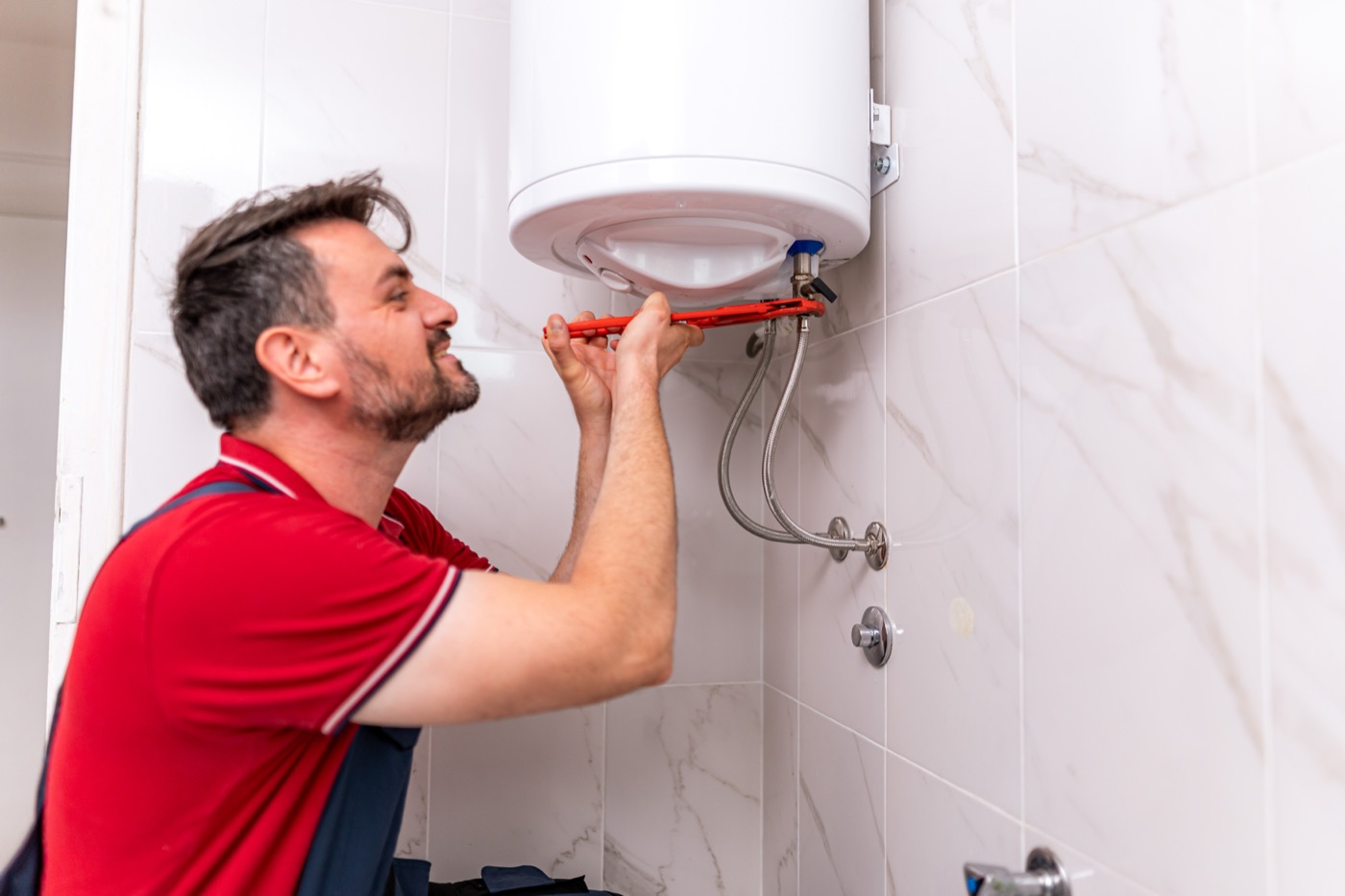 Plumber repairing a storage hot water system at a Kinross home Plumber repairing a storage hot water system at a Kinross home